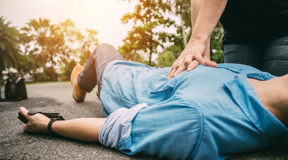 individual performing CPR on a man