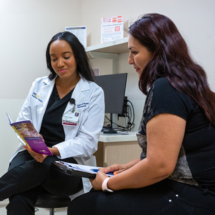 pharmacist and patient reviewing docs