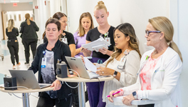 hospital staff meeting in a hallway