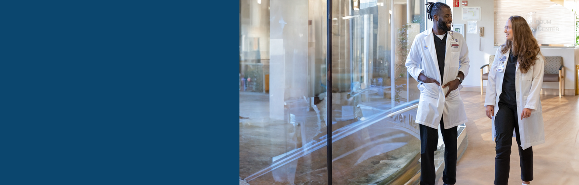 header with a male and female pharmacist walking