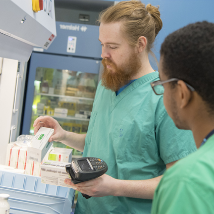 two pharmacy techs verifying meds
