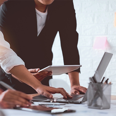 two individuals working on a laptop