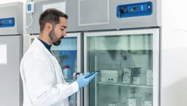 pharmacist looking at refrigerated specialty drugs